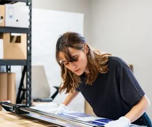 Trimming a fresh print in the studio